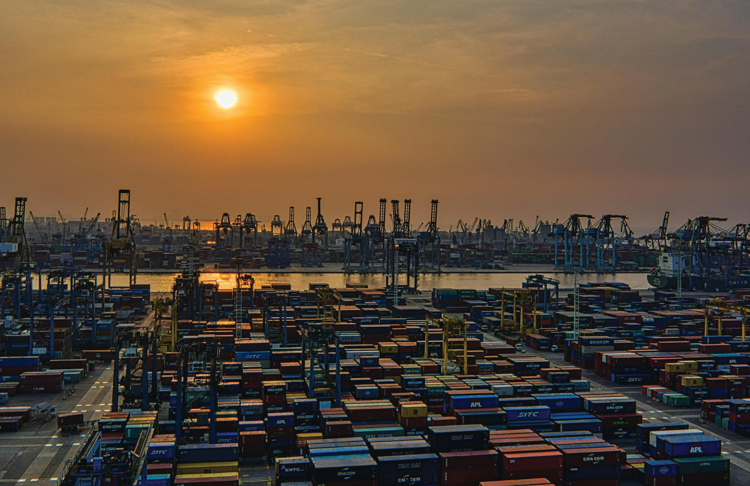 Container port terminal at sunset