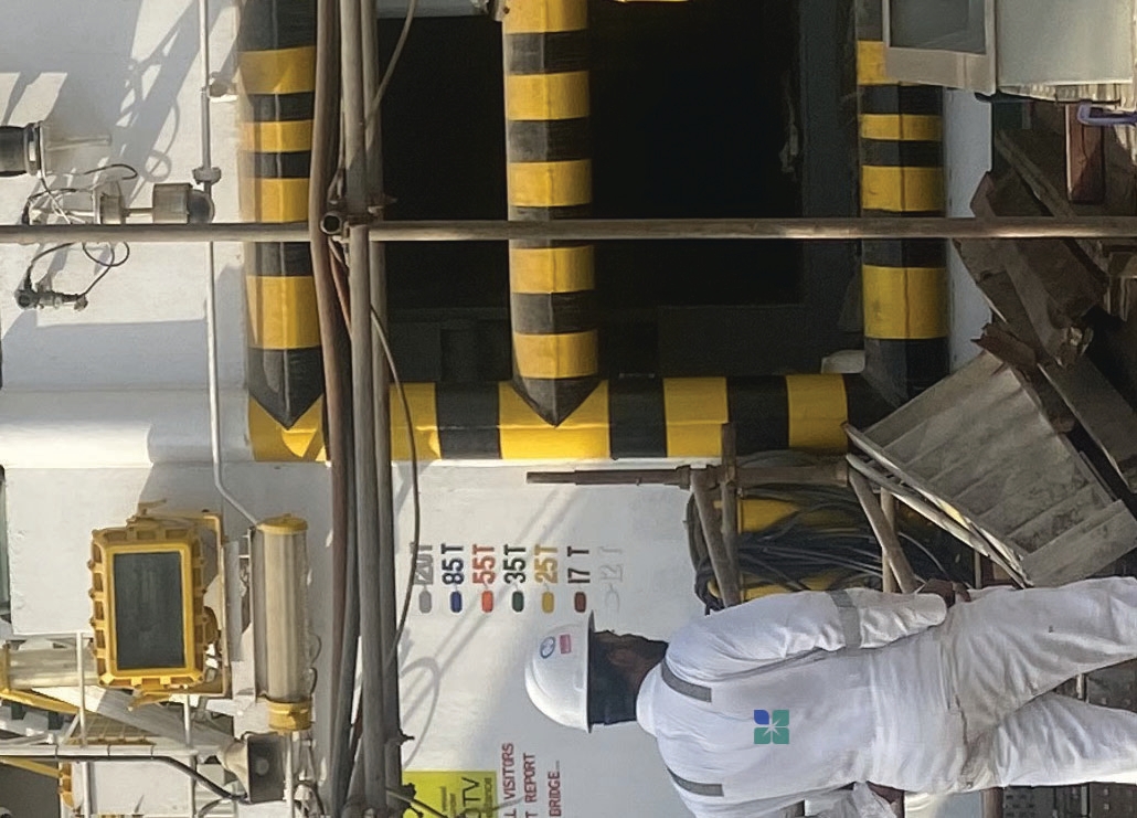 Technician inspecting ship deck equipment onsite